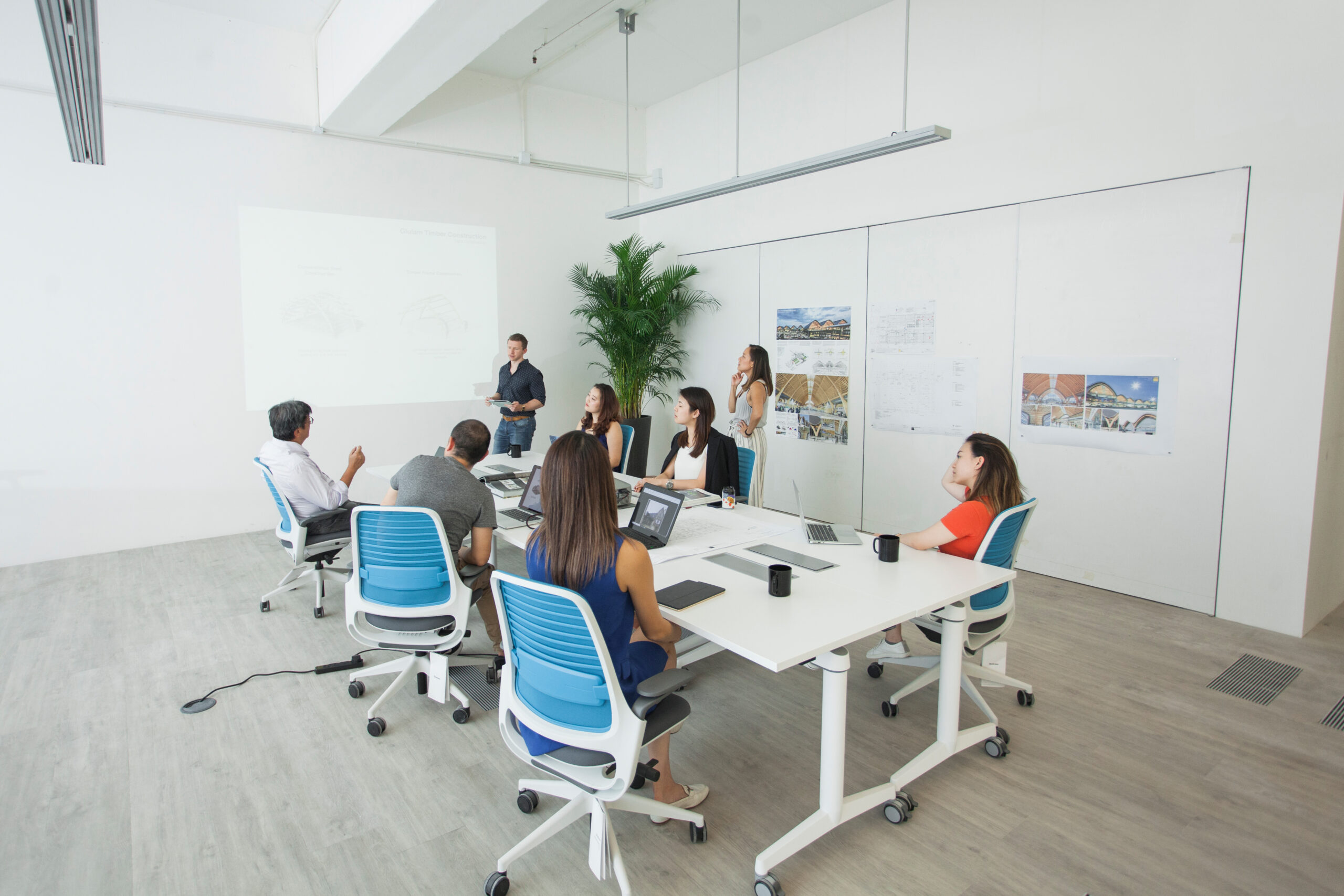 A group of people coworking in a conference room at a coworking space in Hong Kong.