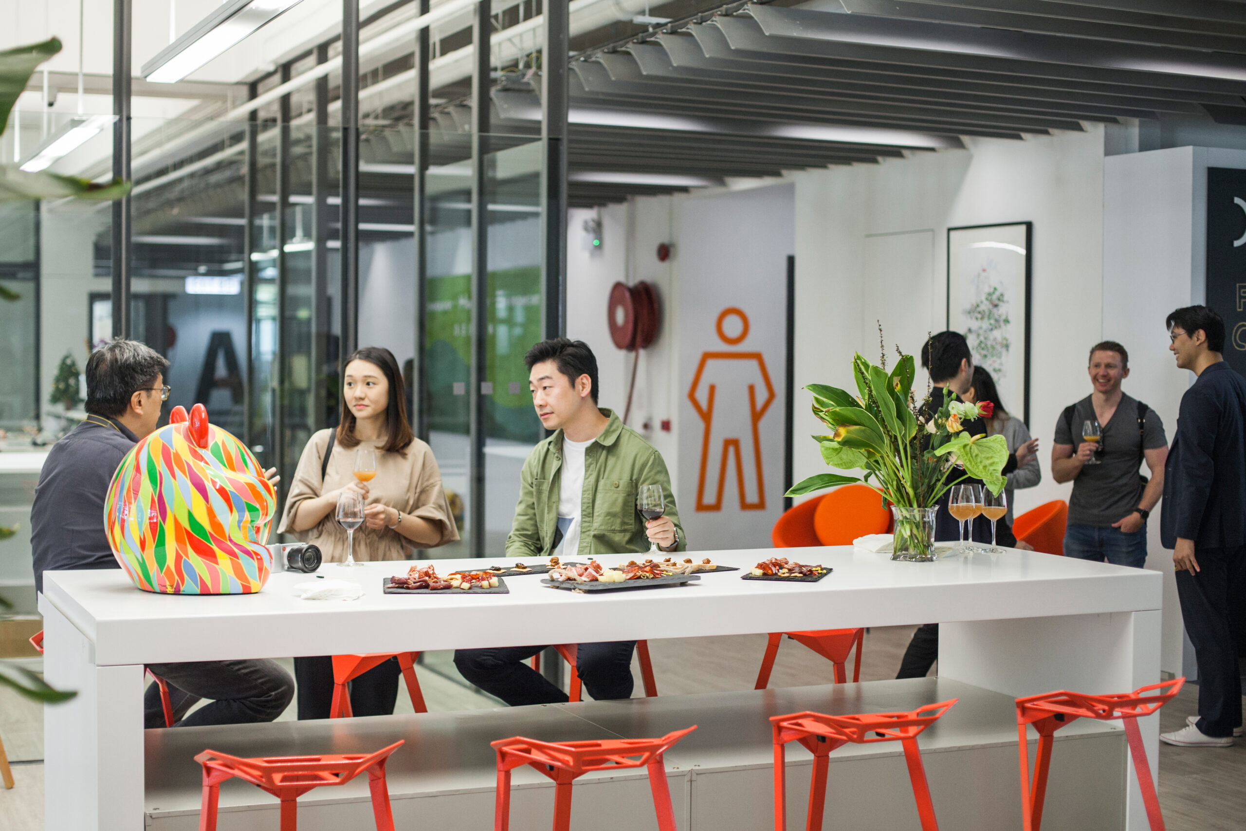 A group of people sitting around a table in a coworking space.